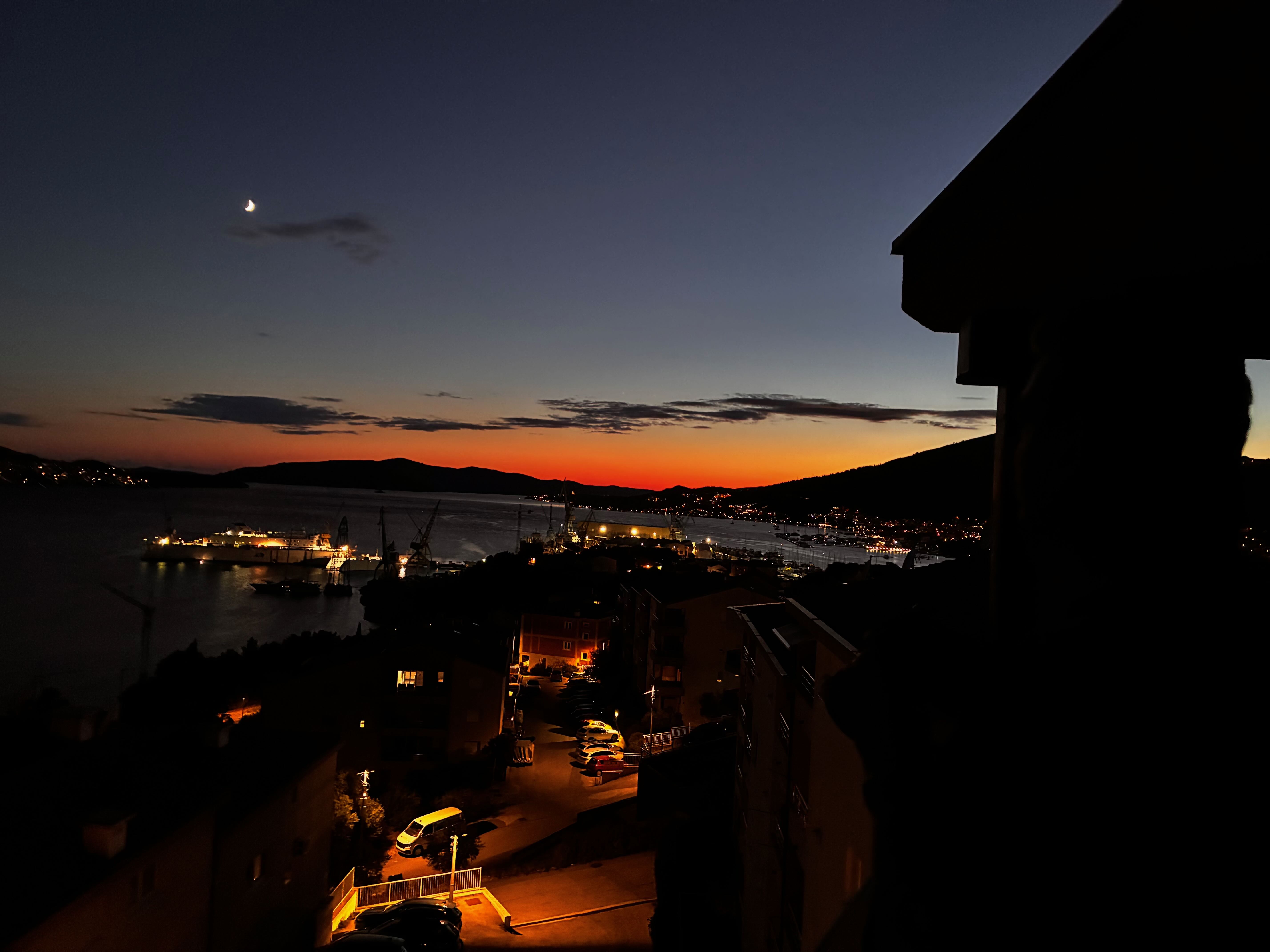 Evening mood over the sea with harbor lights