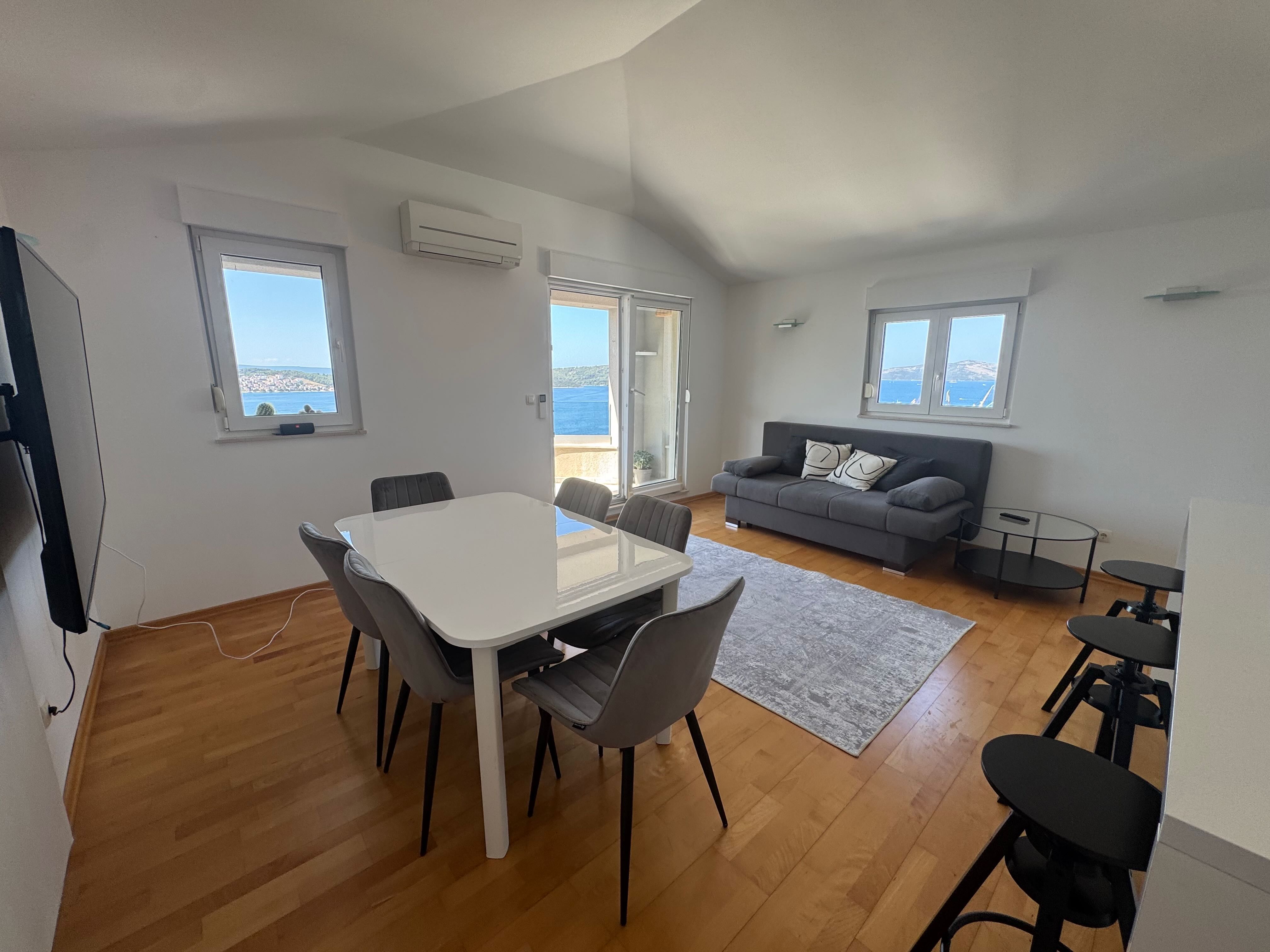 Bright living room with sofa and dining area