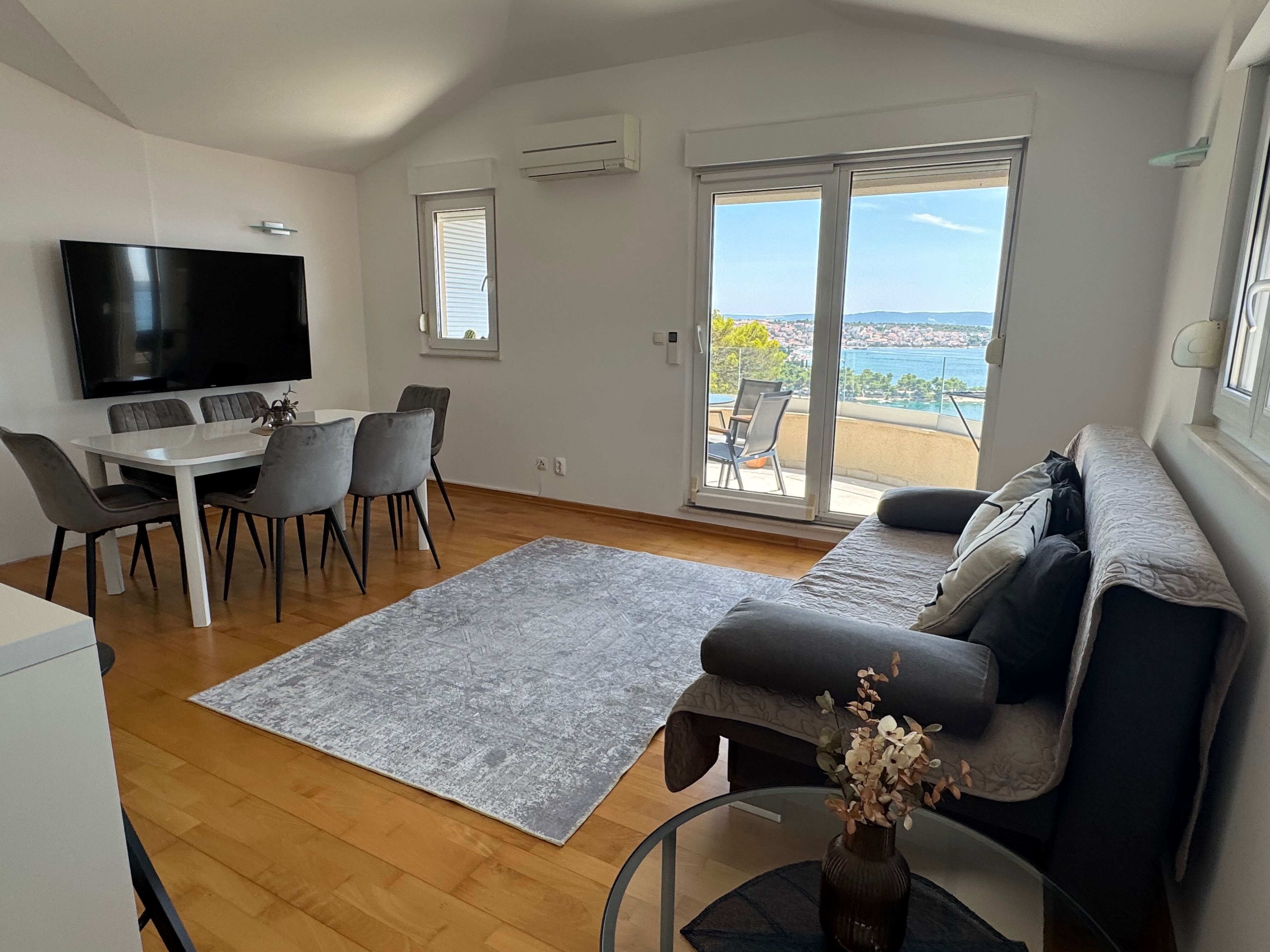 Living area with large window and sea view